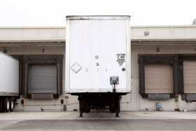 Loading dock with a truck trailer attached for unloading and loading of products into a warehouse